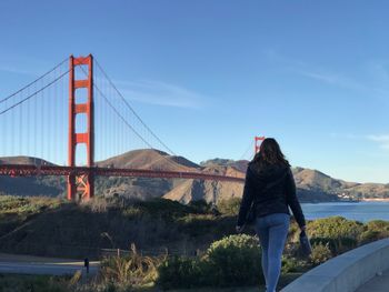 Woman standing against golden gate bridge