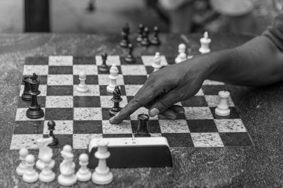 Cropped hand playing chess