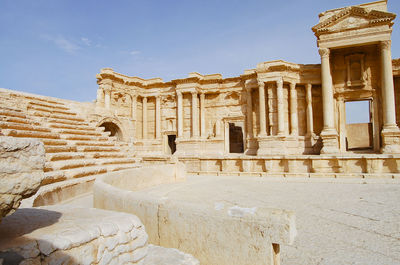 Ancient temple against sky in city