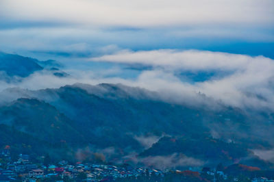 Aerial view of mountains against blue sky