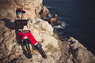 Portrait of a pirate woman at the beach. in anticipation of a pirate ship