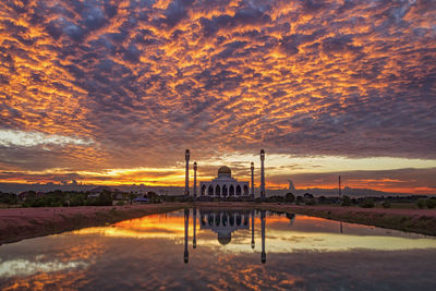 Mosque against cloudy sky during sunset