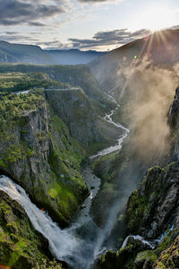 Scenic view of waterfall against sky