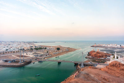 Panorama on west and east part of the sur connected by al ayjah bridge, golden hour. sur, oman