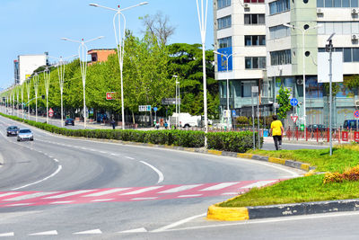 Vehicles on road along buildings
