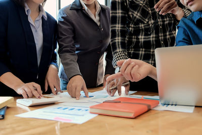 Group of people using laptop on table
