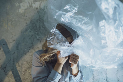 High angle view of woman holding umbrella at sea shore