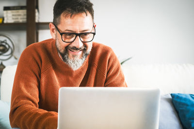 Young man using laptop at home