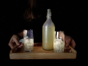 Midsection of wine glasses on table