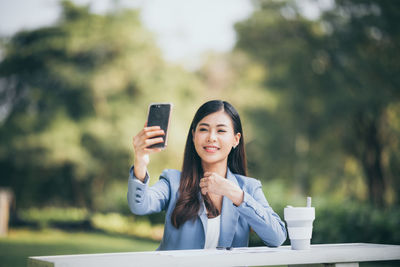 Young woman using mobile phone outdoors