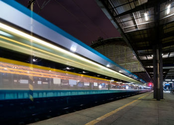 Train at railroad station platform at night