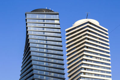 Low angle view of modern building against clear blue sky