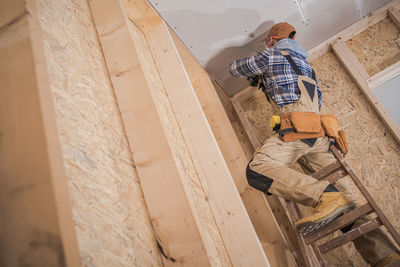 Rear view of man working at construction site