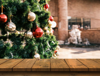 Wooden table with free space on christmas tree blur background. new year concept.
