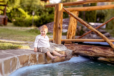 Portrait of boy sitting in water