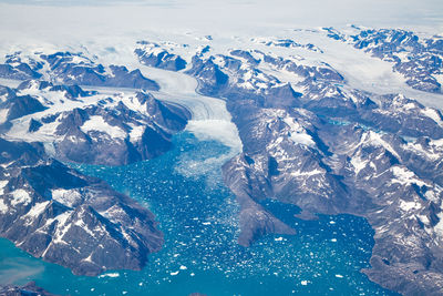 High angle view of snowcapped mountains and sea