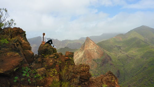 Woman tourist resting in mountain peak. risco blanco. tenerife canary island.