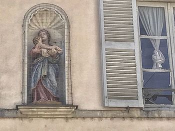 Close-up of statue against building