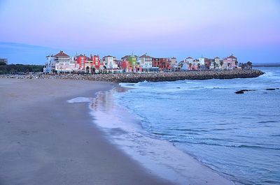 Scenic view of beach against sky during sunset