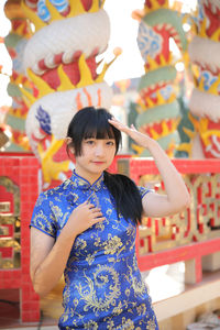 Portrait of young woman standing outdoors