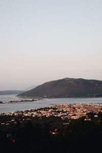 Scenic view of sea and mountains against clear sky