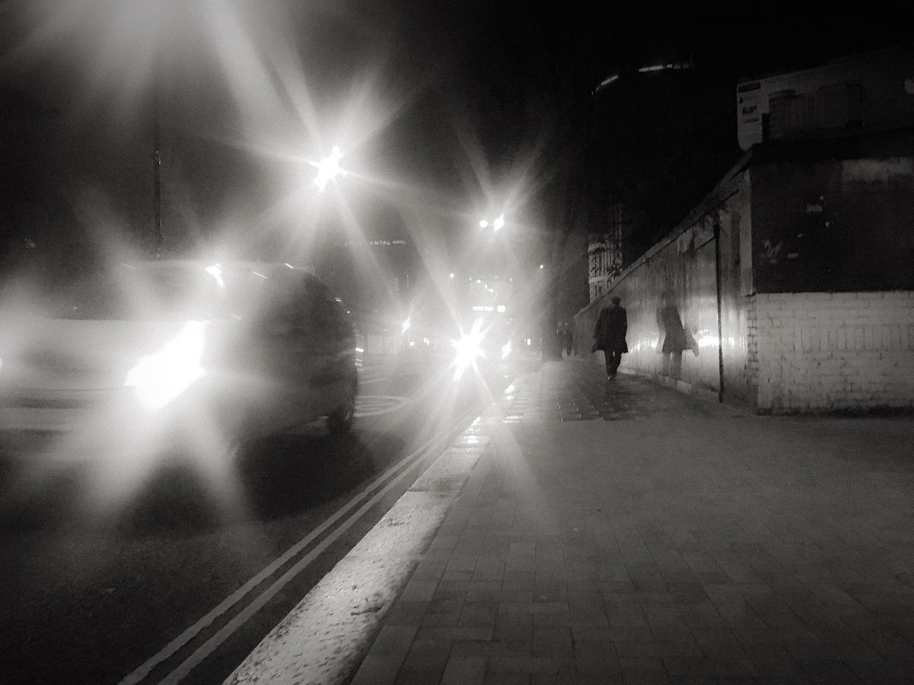 ILLUMINATED STREET AGAINST SKY AT NIGHT