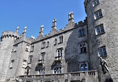 Low angle view of buildings against blue sky