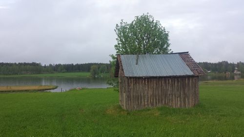 Scenic view of grassy field against cloudy sky