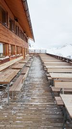 Tables and bench on building terrace during winter