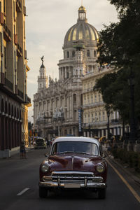 Cars on city street with buildings in background