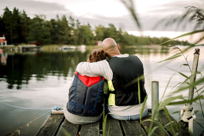 Rear view of couple kissing in lake