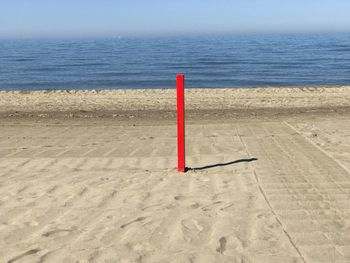 Lifeguard hut on beach against sky