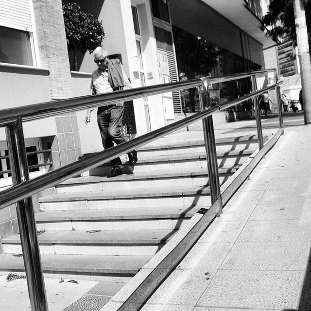 built structure, architecture, building exterior, railing, steps, staircase, steps and staircases, lifestyles, city, building, men, footbridge, day, sunlight, walking, wood - material, outdoors, person