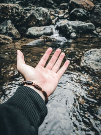 Midsection of person on rock
