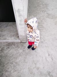 High angle view of girl standing with umbrella