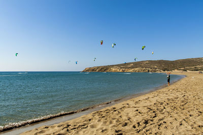 Scenic view of beach against clear blue sky