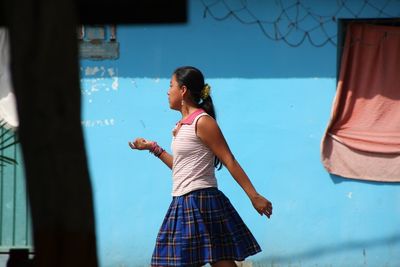 Woman standing against wall