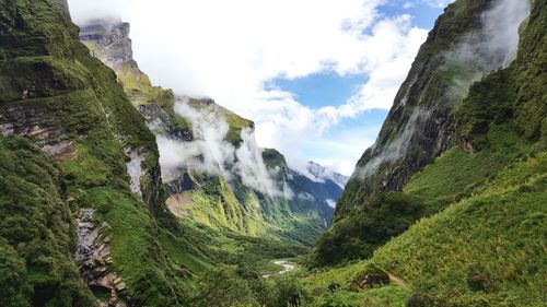 Scenic view of green mountains against sky