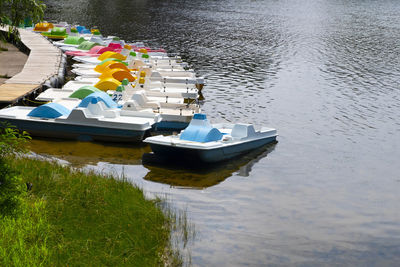 Parking catamarans on the city beach in summer. the river bank. boat rental