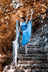 Side view of young woman standing in park