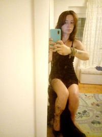 Full length portrait of young man using mobile phone