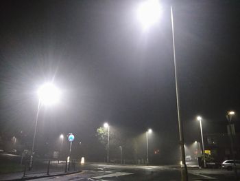 Illuminated road against clear sky