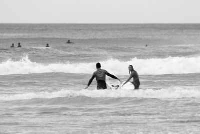 Man with surfboard on beach
