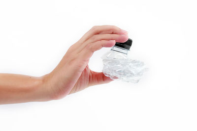 Midsection of woman holding paper against white background