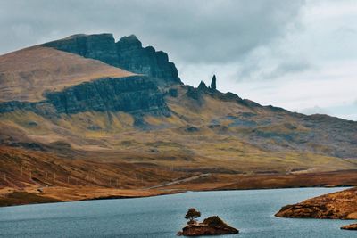Rock formations by sea against sky
