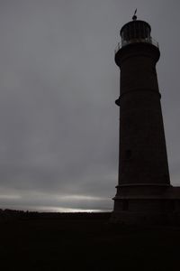 Low angle view of lighthouse against sky at dusk