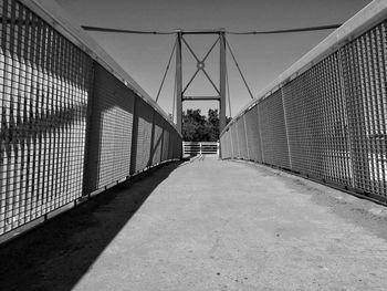 Bridge over empty footbridge against sky