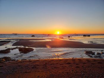 Scenic view of sea against clear sky during sunset