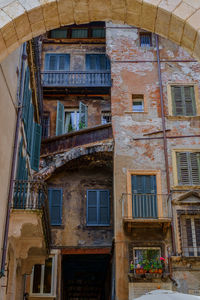 Low angle view of old building seen through arch