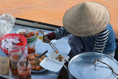 High angle view of man holding ice cream on table